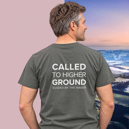 Model wearing the 'Called to higher ground' back print tee in charcoal, large message printed on the back - Blend Designs NZ