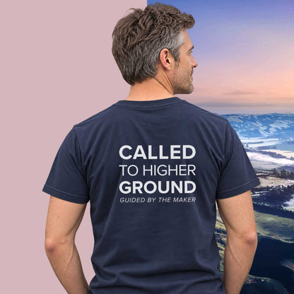 Model wearing the 'Called to higher ground' back print tee in navy, large message printed on the back - Blend Designs NZ