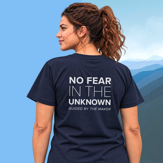 Model wearing the 'No fear in the unknown' back print tee in navy, large message printed on the back - Blend Designs NZ