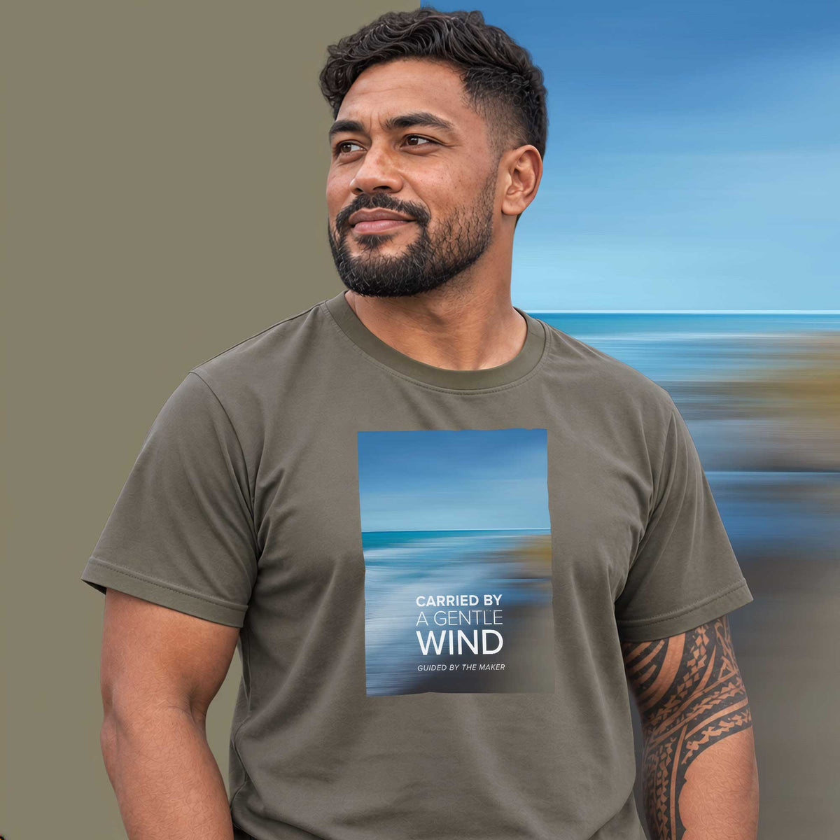 Model wearing the Ocean Breeze graphic tee in charcoal, soft blue ocean shoreline print - Blend Designs NZ