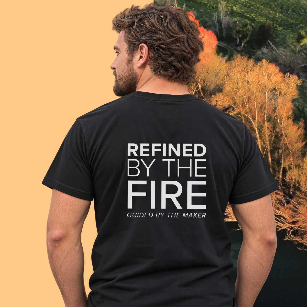 Model wearing the 'Refined by the fire' back print tee in black, large message printed on the back - Blend Designs NZ