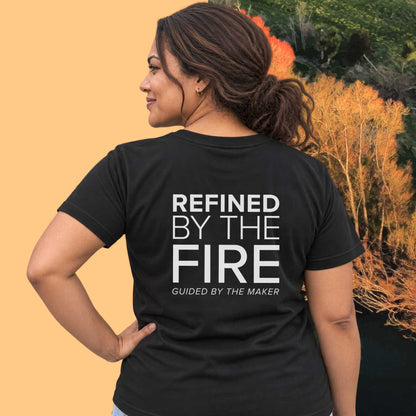 Model wearing the 'Refined by the fire' back print tee in black, large message printed on the back - Blend Designs NZ