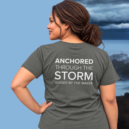 Model wearing the 'Anchored through the storm' back print tee in charcoal, large message printed on the back - Blend Designs NZ