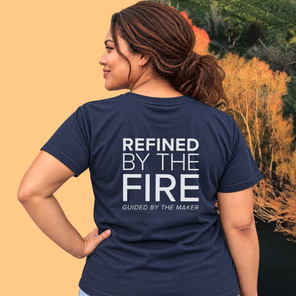 Model wearing the 'Refined by the fire' back print tee in navy, large message printed on the back - Blend Designs NZ