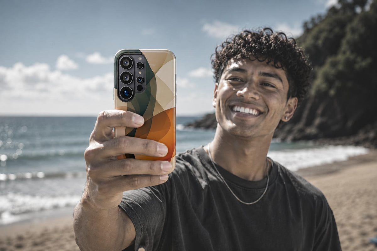 Man on a beach photographing a colorful art-print Blend Designs Samsung phone case