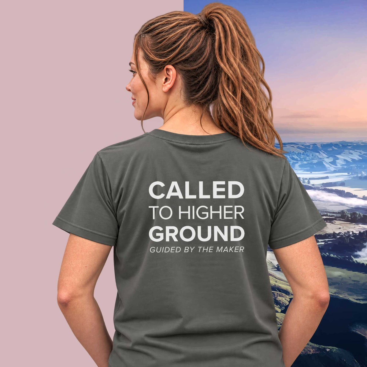 Model wearing the 'Called to higher ground' back print tee in charcoal, large message printed on the back - Blend Designs NZ
