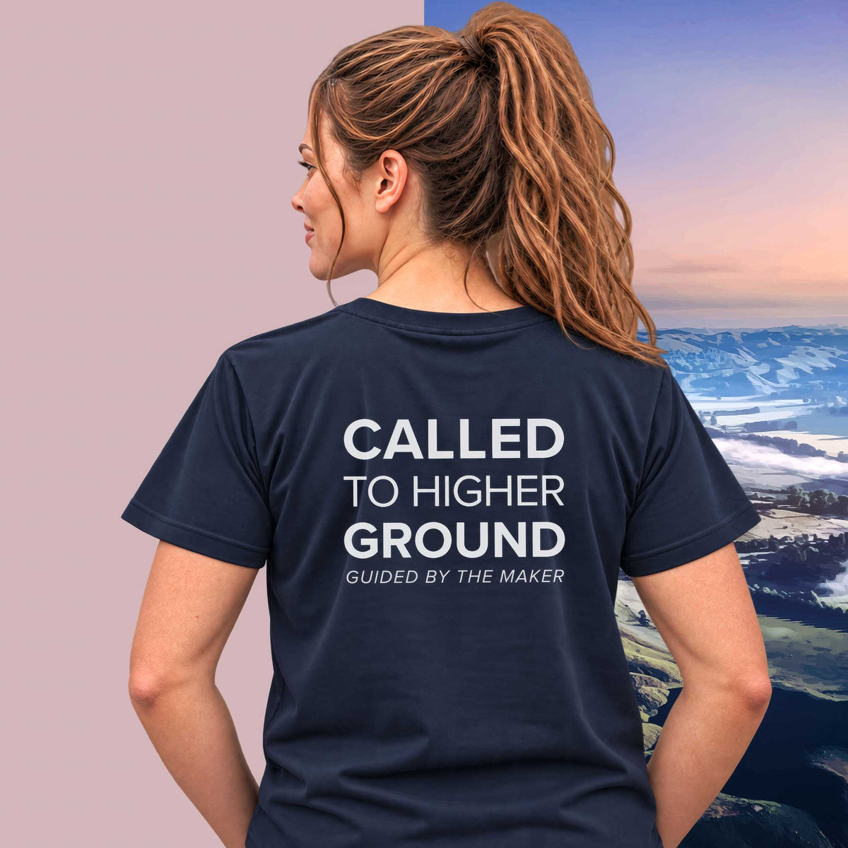 Model wearing the 'Called to higher ground' back print tee in navy, large message printed on the back - Blend Designs NZ