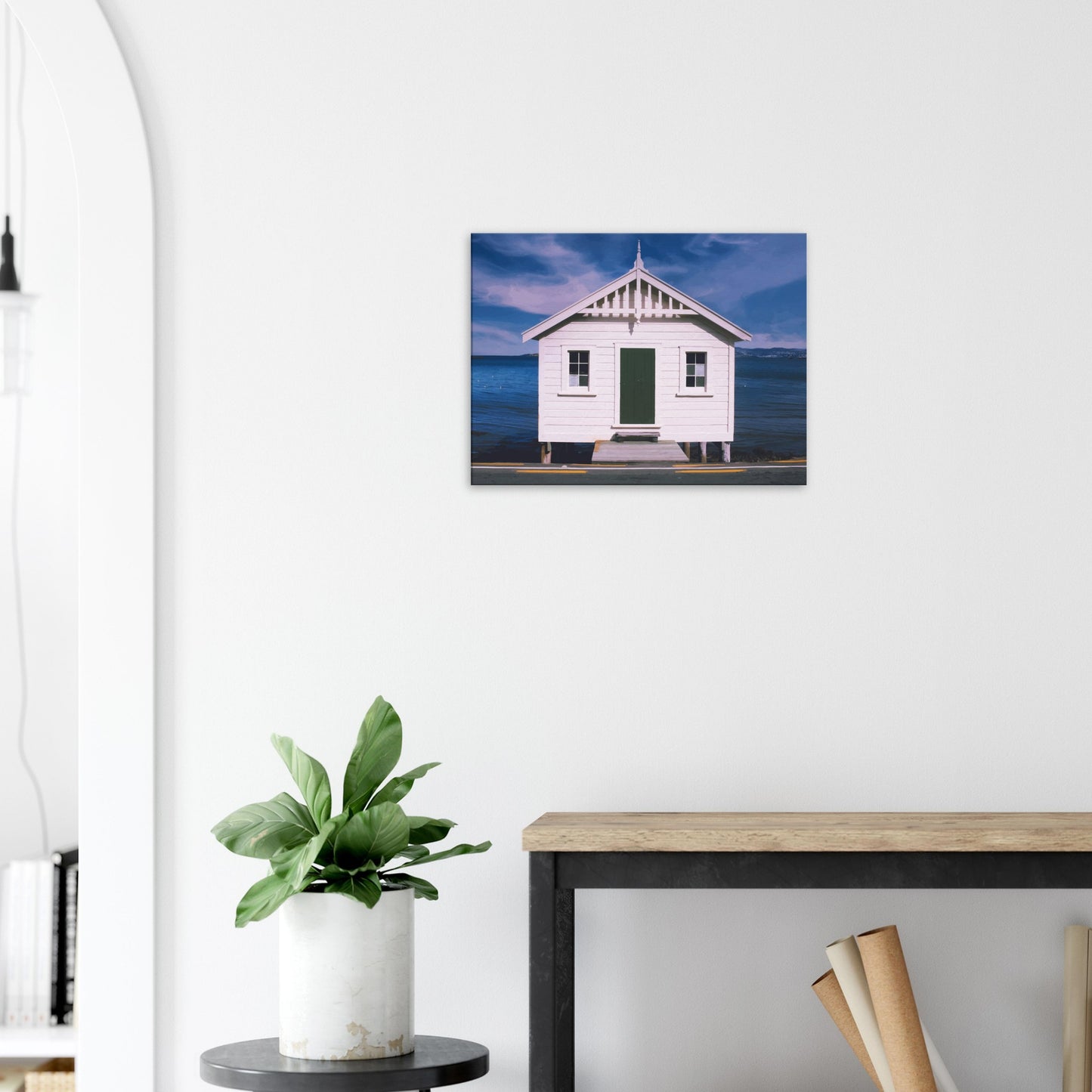 White boat shed by the sea under a blue sky in Eastbourne, New Zealand – bright and coastal.