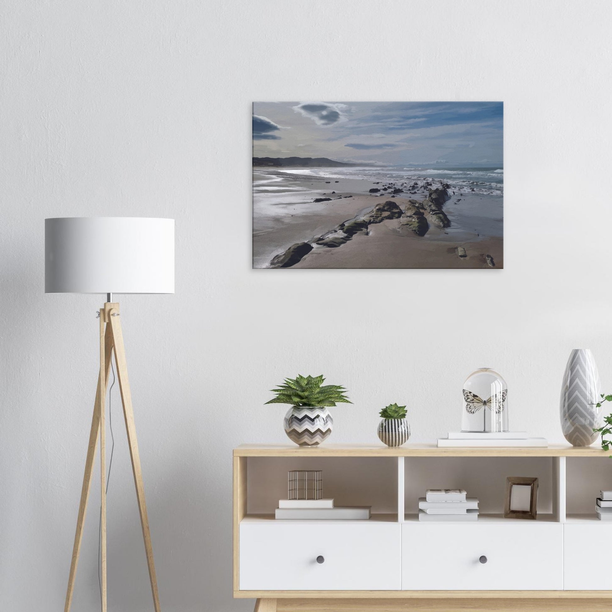 A moody, windswept beach and a line of sea-weathered rocks stretching into the distance, this artwork captures the raw, untouched feel of a wild shoreline.