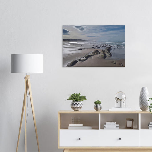 A moody, windswept beach and a line of sea-weathered rocks stretching into the distance, this artwork captures the raw, untouched feel of a wild shoreline.