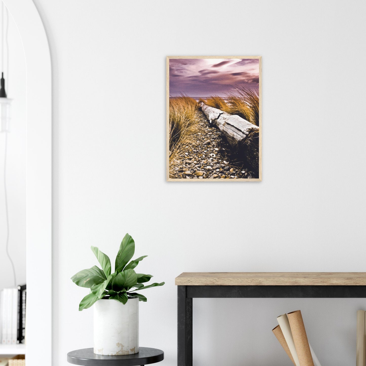Driftwood lying in coastal grasses under a purple sky, evoking weathered texture and calm.
