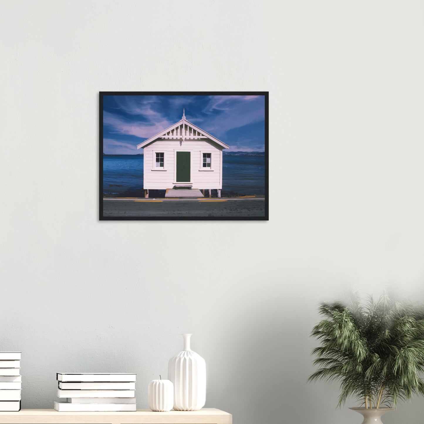 White boat shed by the sea under a blue sky in Eastbourne, New Zealand – bright and coastal.