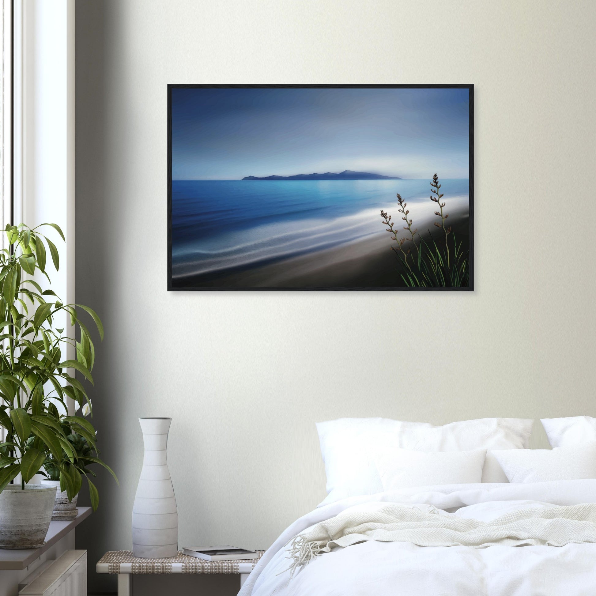 Kapiti Island with soft blue sea, gentle waves and native flax in the foreground.