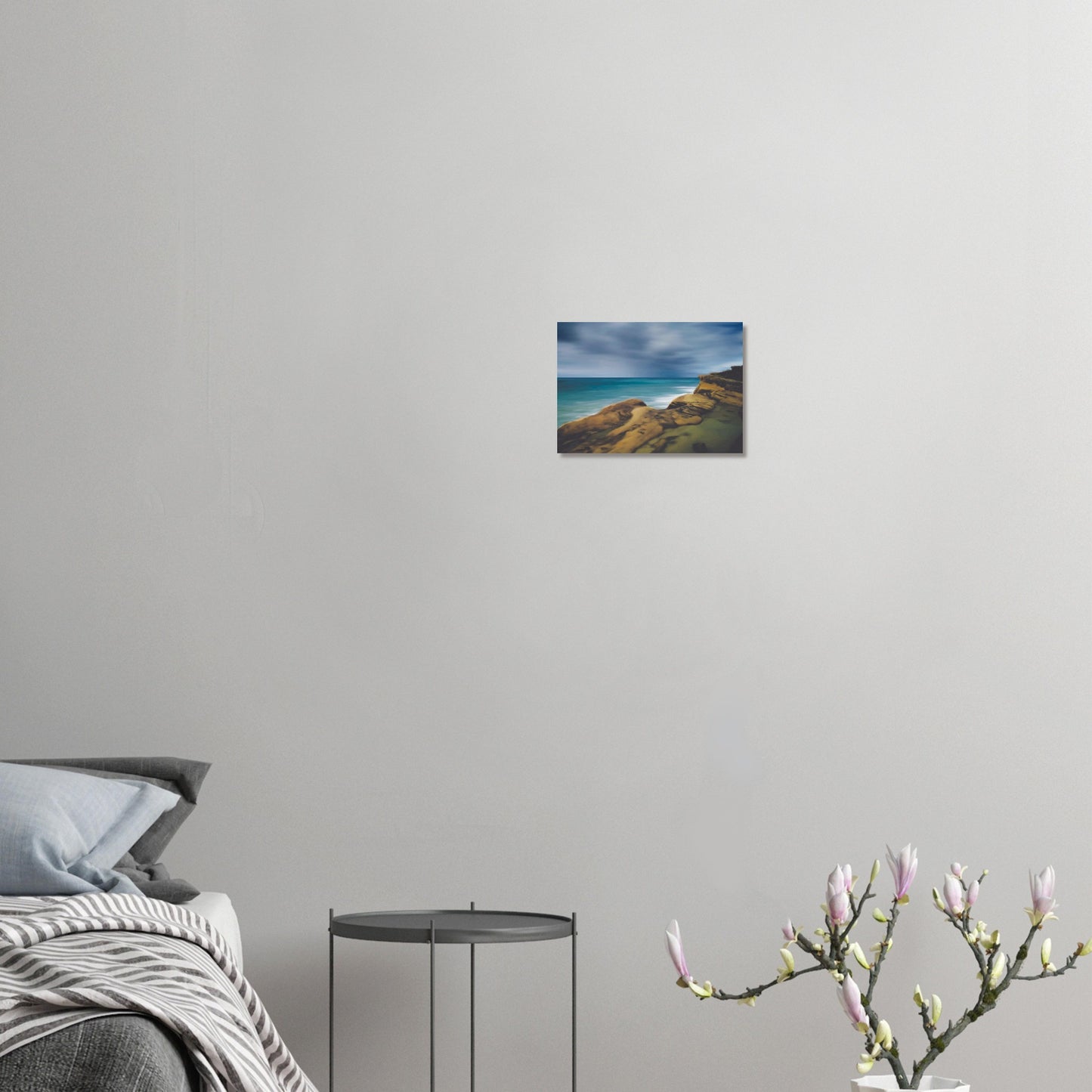 Moody seascape artwork of Castlepoint, with cliffs in the foreground and dark ocean under a brooding sky.