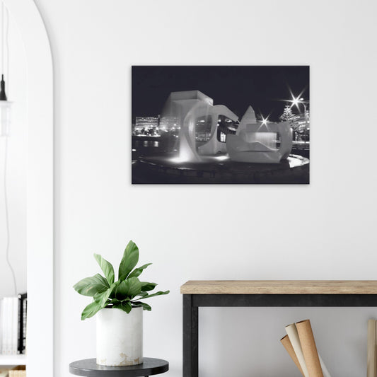 Monochrome artwork of Wellington’s Albatross Fountain lit at night, featuring bold sculptural lines and soft lighting.