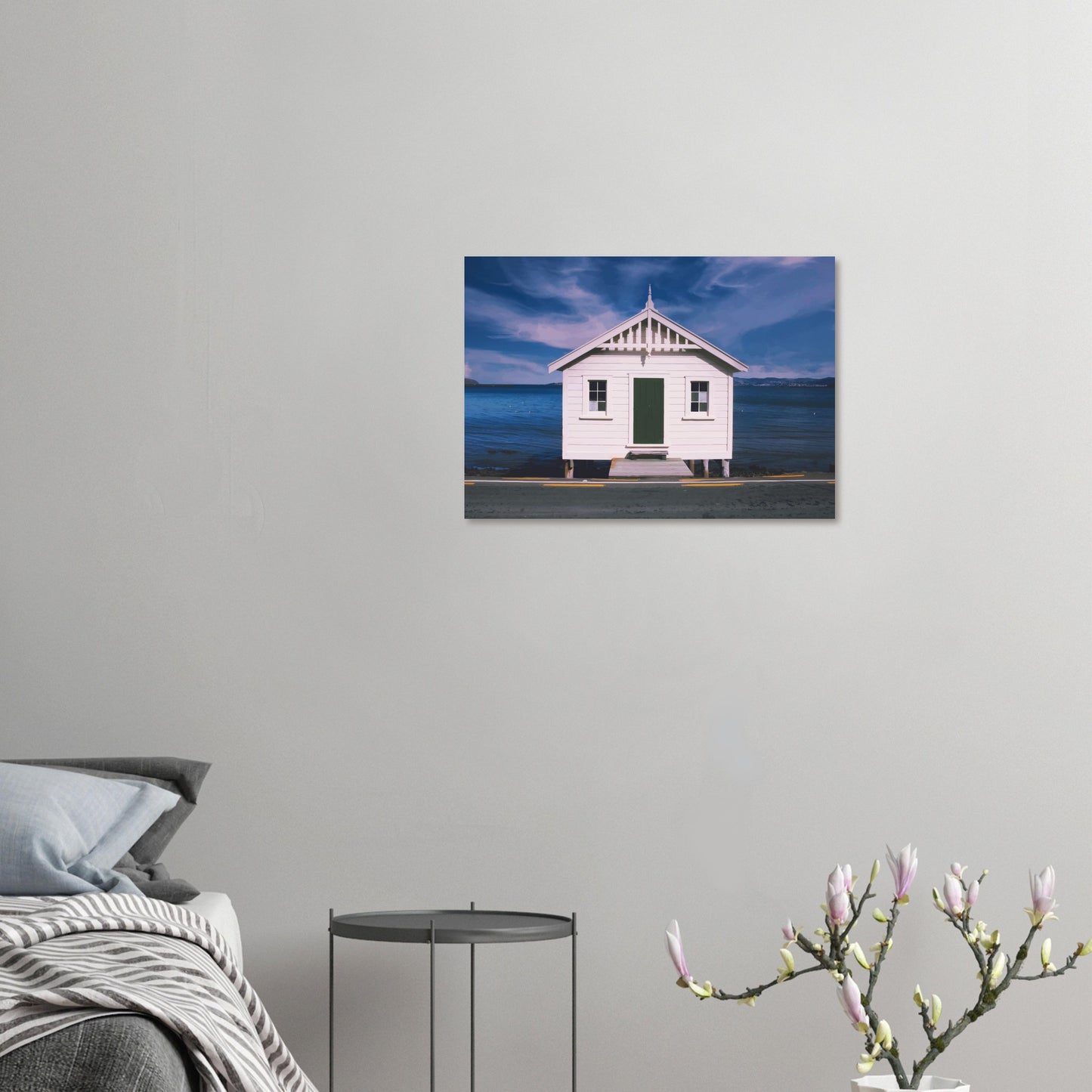 White boat shed by the sea under a blue sky in Eastbourne, New Zealand – bright and coastal.