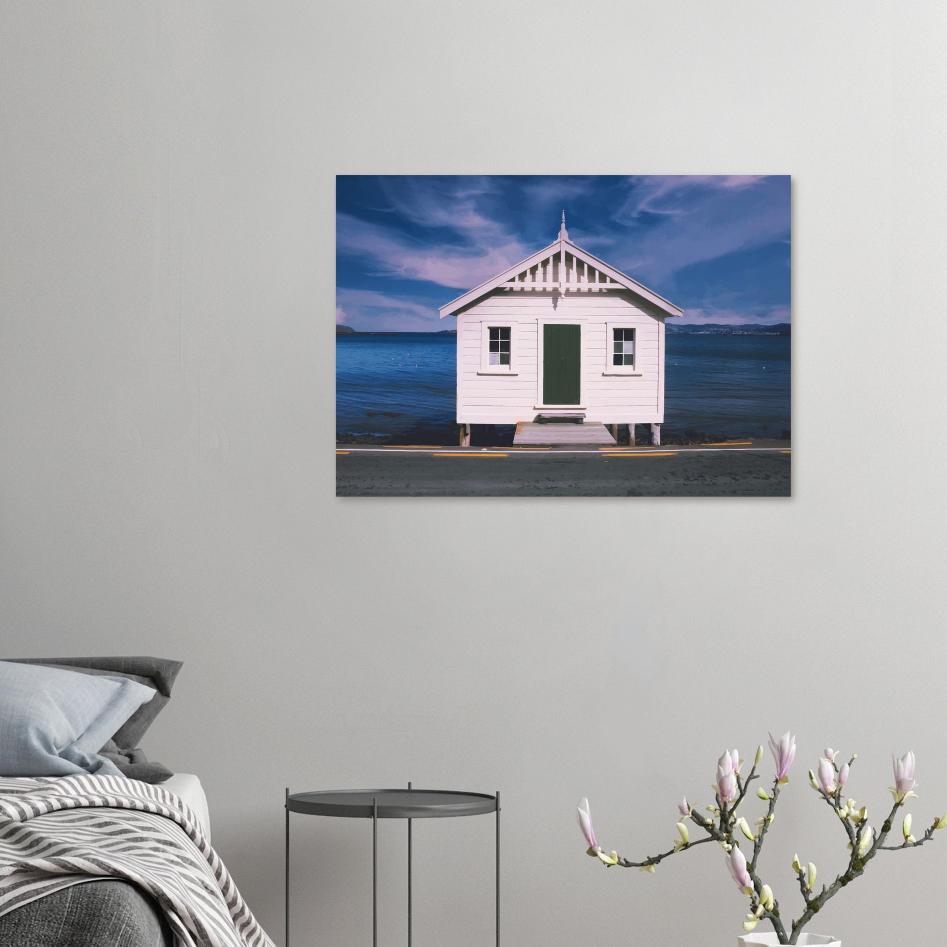 White boat shed by the sea under a blue sky in Eastbourne, New Zealand – bright and coastal.