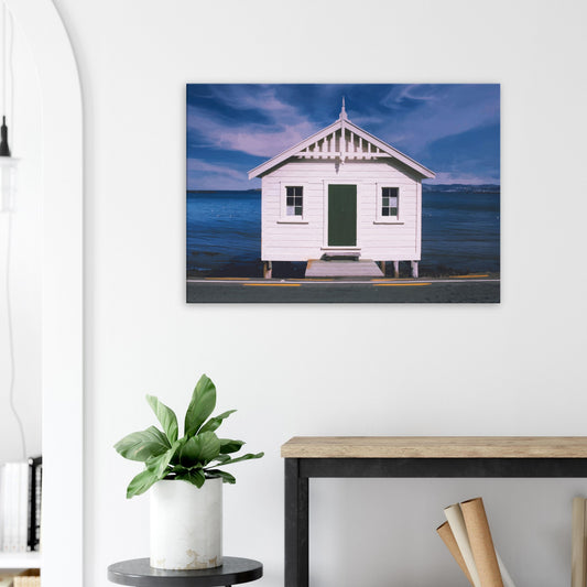 White boat shed by the sea under a blue sky in Eastbourne, New Zealand – bright and coastal.