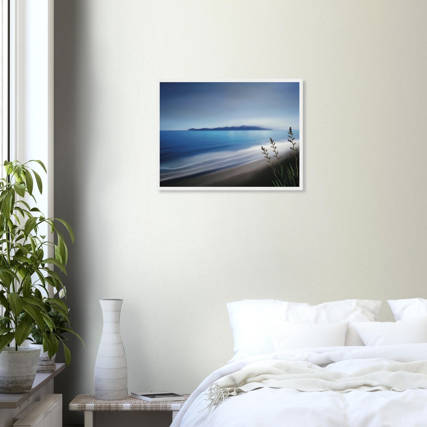 Kapiti Island with soft blue sea, gentle waves and native flax in the foreground.