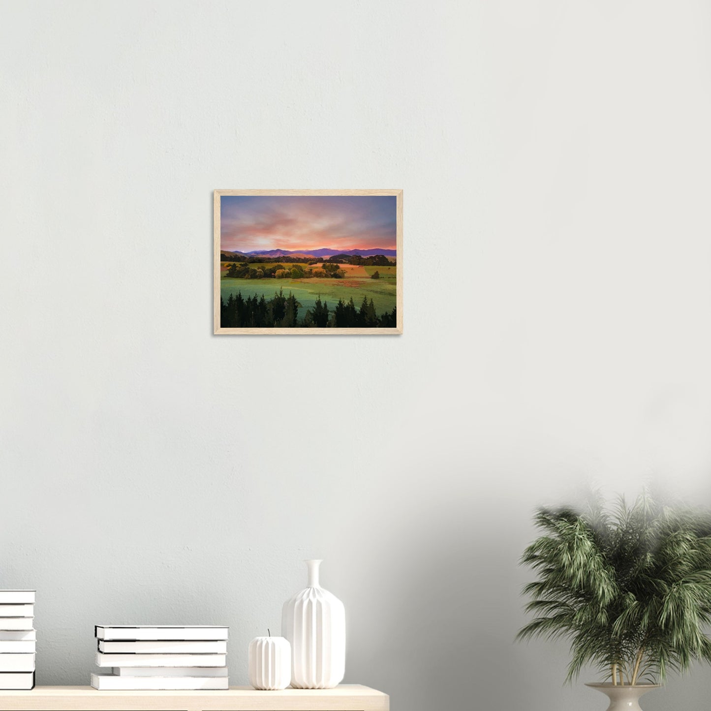 Artwork of a Wairarapa sunrise over pine trees and rolling farmland with soft light on the Tararua Ranges.