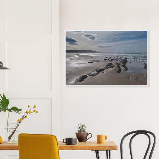 A moody, windswept beach and a line of sea-weathered rocks stretching into the distance, this artwork captures the raw, untouched feel of a wild shoreline.