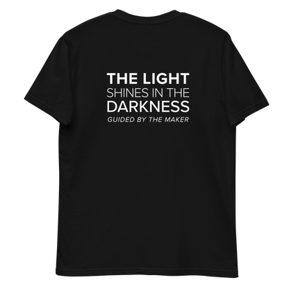 'The light shines in the darkness' back print tee in black, back view mockup showing the large message print