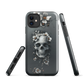 Gothic phone case with a floral skull design in grey tones, featuring white blossoms and dark detailing.
