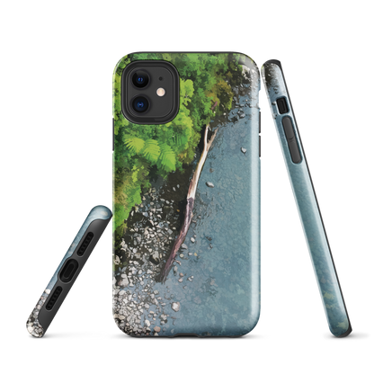 Resting Place phone case with aerial artwork of river rocks, green bush, and driftwood in a New Zealand stream.