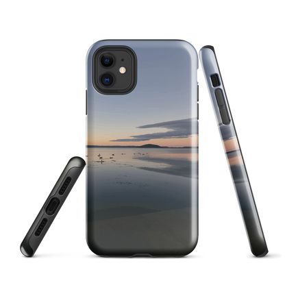 Phone case with tranquil lake scene at sunrise and distant hills.