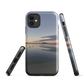 Phone case with tranquil lake scene at sunrise and distant hills.