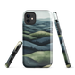 Phone case with layered mountain and forest landscape in blue and green hues