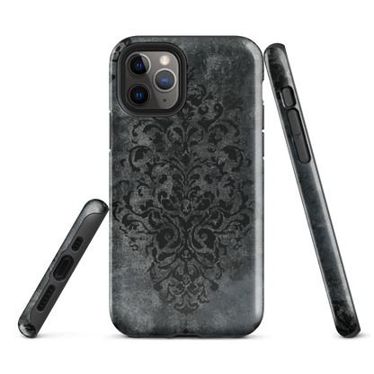 Dark damask patterned phone case with a vintage gothic aesthetic and textured stone background.