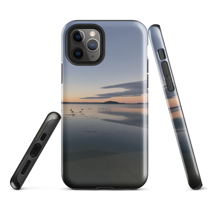 Phone case with tranquil lake scene at sunrise and distant hills.