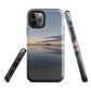 Phone case with tranquil lake scene at sunrise and distant hills.
