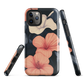 Phone case with coral hibiscus flowers and ivory blooms on dark background