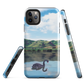 Phone case with a black swan on a calm lake, New Zealand hills in the background. Art by NZ designer Ben Hart.