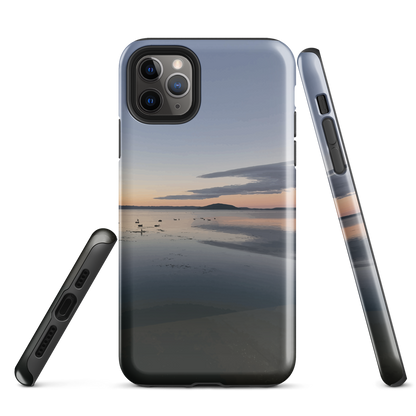 Phone case with tranquil lake scene at sunrise and distant hills.
