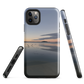 Phone case with tranquil lake scene at sunrise and distant hills.