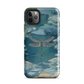 Nature-inspired phone case featuring a dragonfly over calm water with blue and green forest tones.
