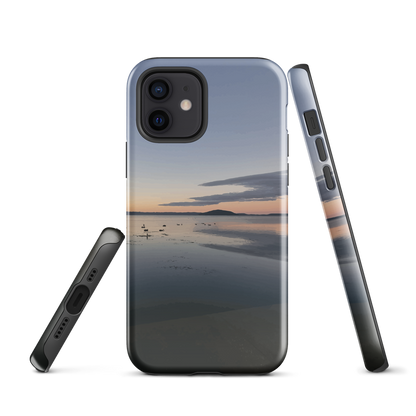 Phone case with tranquil lake scene at sunrise and distant hills.