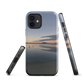 Phone case with tranquil lake scene at sunrise and distant hills.