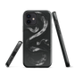 Phone case with detailed black python design on dark background.