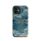 Nature-inspired phone case featuring a dragonfly over calm water with blue and green forest tones.