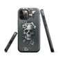 Gothic phone case with a floral skull design in grey tones, featuring white blossoms and dark detailing.