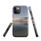 Phone case with tranquil lake scene at sunrise and distant hills.