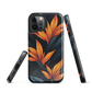 Phone case with bold orange bird of paradise flowers on dark background.