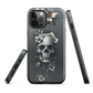 Gothic phone case with a floral skull design in grey tones, featuring white blossoms and dark detailing.