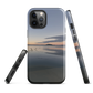 Phone case with tranquil lake scene at sunrise and distant hills.