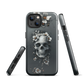 Gothic phone case with a floral skull design in grey tones, featuring white blossoms and dark detailing.