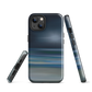 Dark abstract phone case with blue and grey streaks and glossy finish.